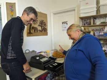 Jean-Jacques and Rosie using the till