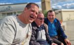 Three male members sitting on a bench in Ramsgate