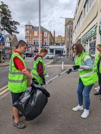 Community clear up group in action collecting litter