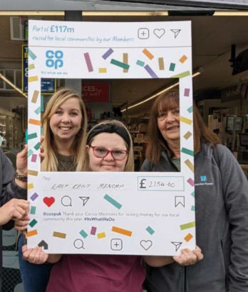 Amy at Co-op collecting cheque