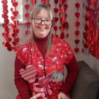 Herne Bay Hub Valentine's Day event with member holding Valentine's craft