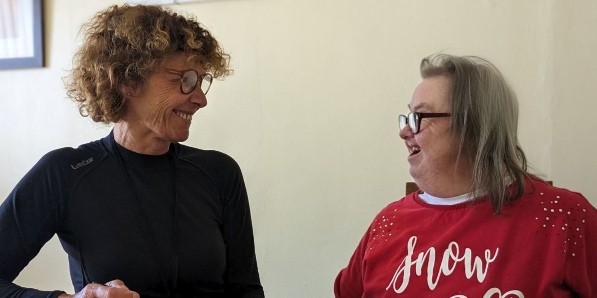 Support Worker looking at female tenant smiling