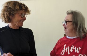 Support Worker looking at female tenant smiling