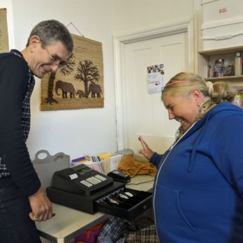 Jean-Jacques shows Rosie how to use the till