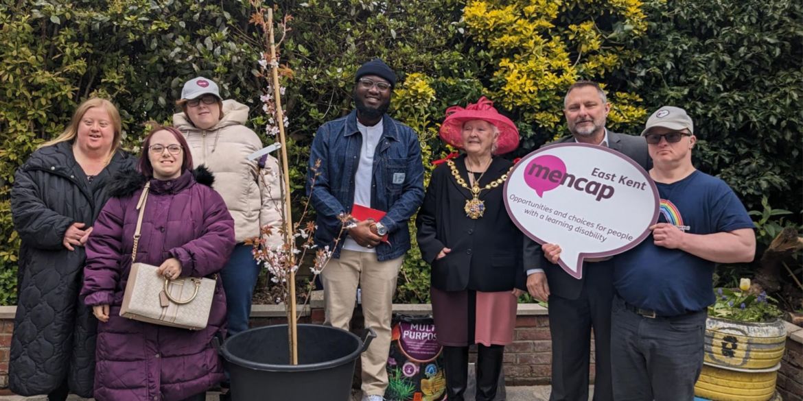 Six people in the Ramsgate Hub garden with the Mayor of Ramsgate planting a tree to celebrate our 75th anniversary