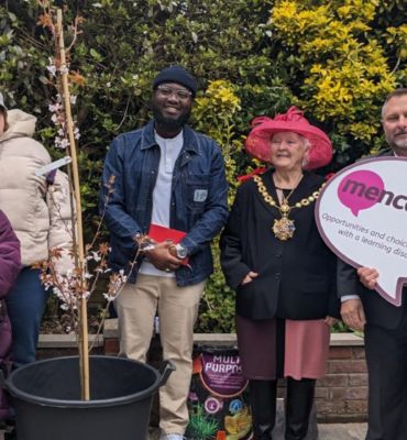 Six people in the Ramsgate Hub garden with the Mayor of Ramsgate planting a tree to celebrate our 75th anniversary