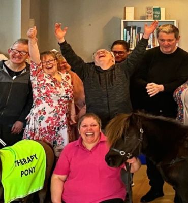 Two brown therapy ponies and members from the Herne Bay Hub