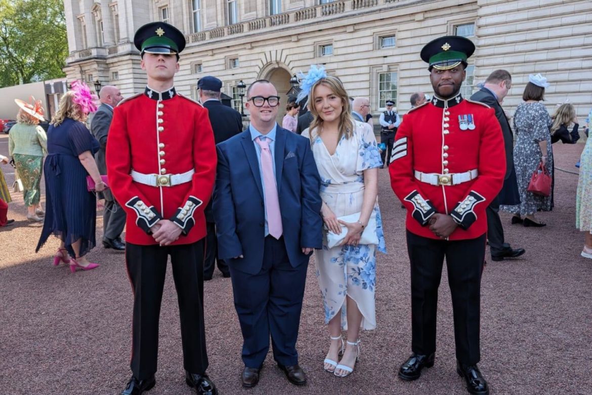 Laurie and Katie with guards outside Buckingham Palace