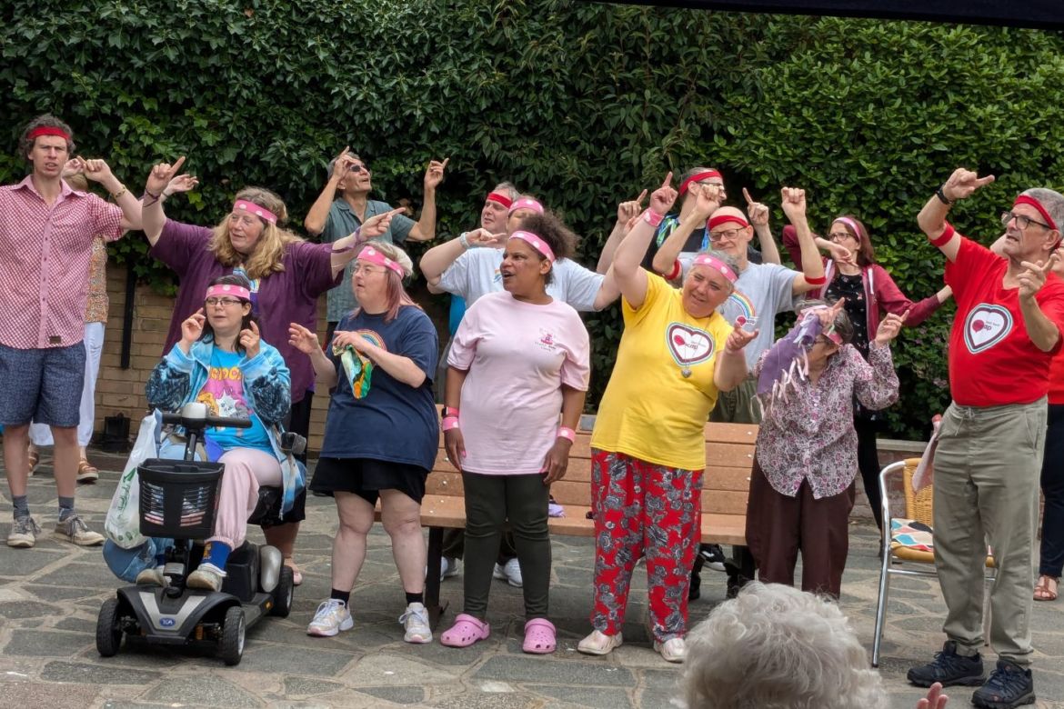 GOLD group in the Foresters Hall garden singing with hands in the air