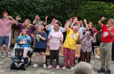 GOLD group in the Foresters Hall garden singing with hands in the air