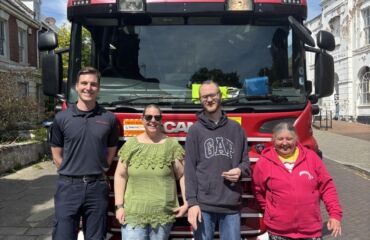 Fire Brigade from Ramsgate, standing in front of a fire engine with some of our members with a learning disability, as they came to chat about fire safety.
