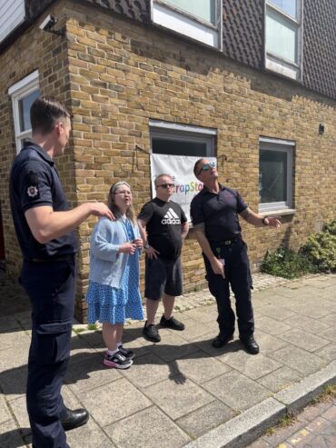 Firemen talking to members with a learning disability about fire safety at Ramsgate.