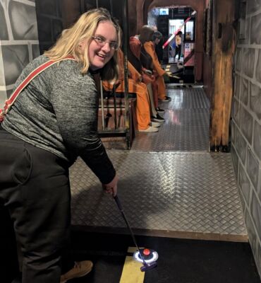 A member with a learning disability playing adventure golf in Maidstone.