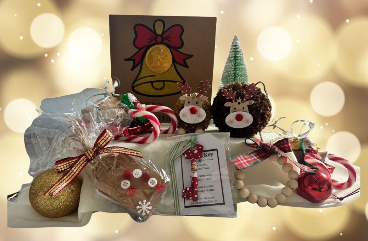 A collection of Christmas presents crafted by East Kent Herne Bay hub members, including pinecone reindeers, festive greeting cards and more. Twinkling white lights sit in the background.